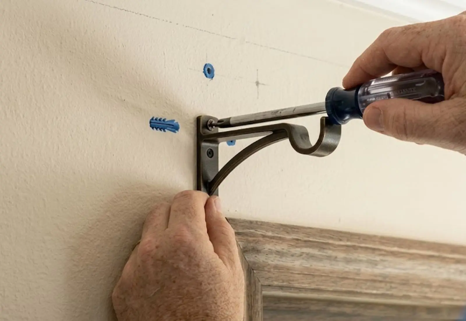 Professional curtain bracket installation on wall mount