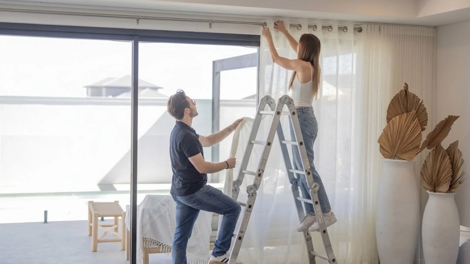 Experienced technician fitting eyelet curtain in Dubai