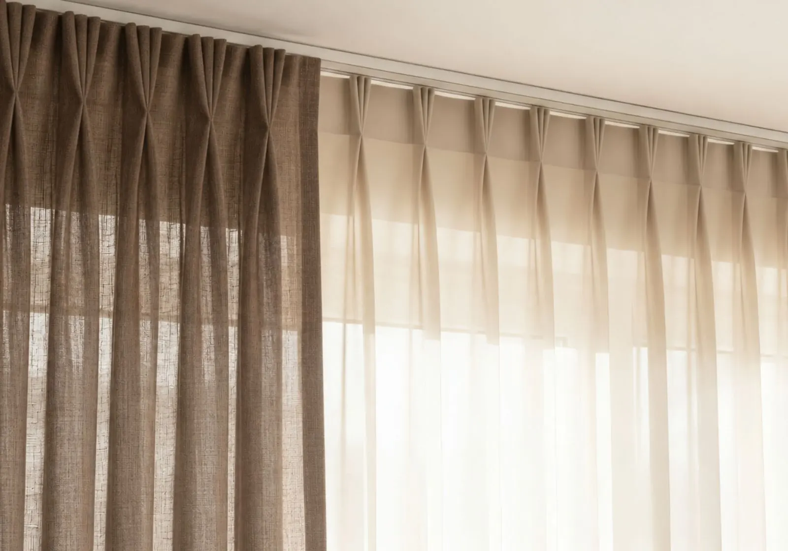 Sheer pinch pleated curtain installed in bright room