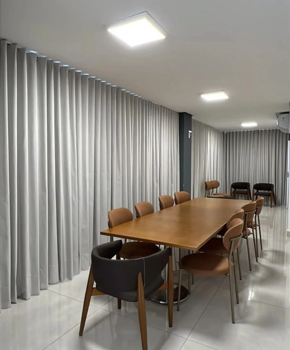 Neat curtain panels hanging in corporate meeting room