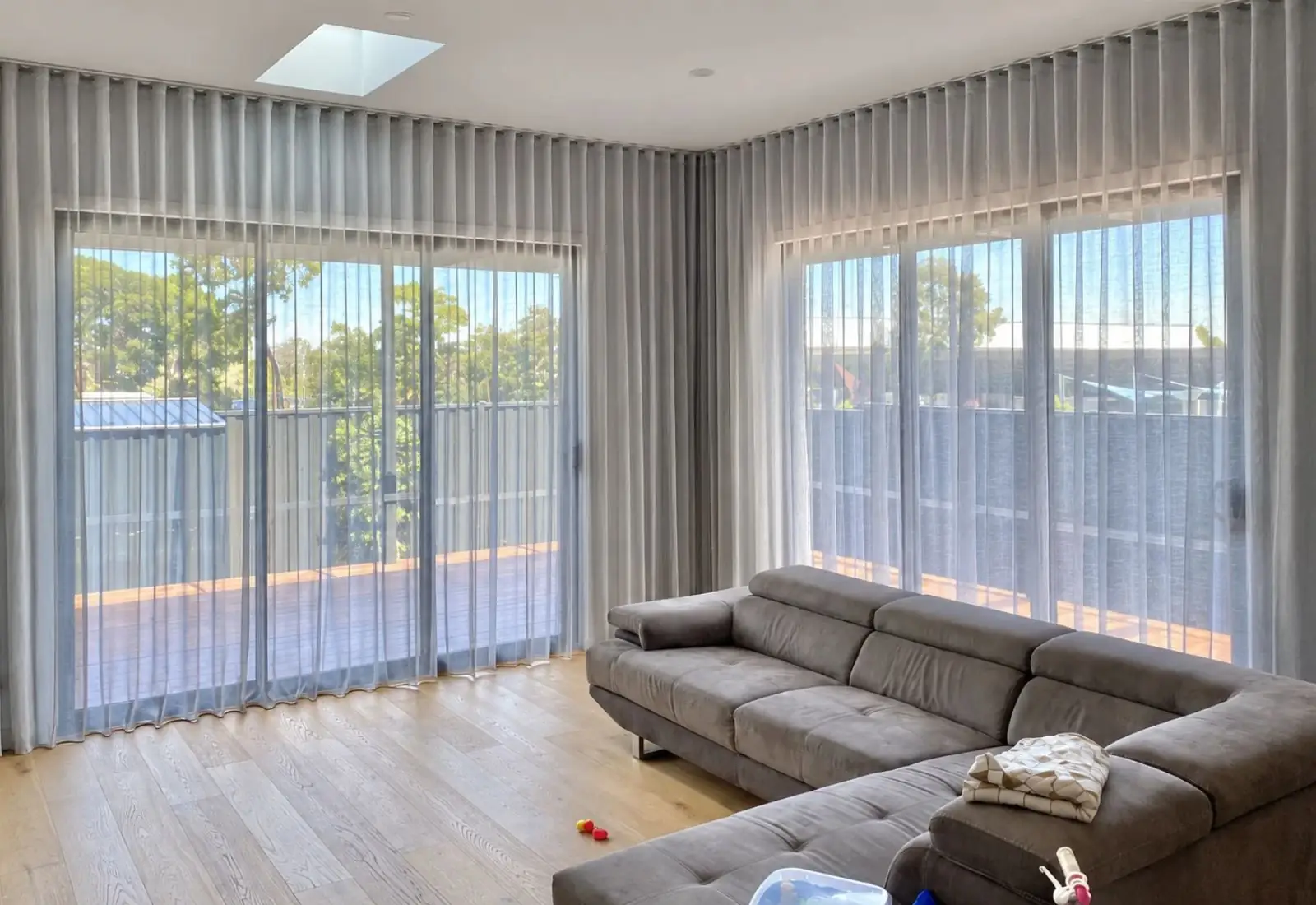 Sheer curtain installed in bright living room