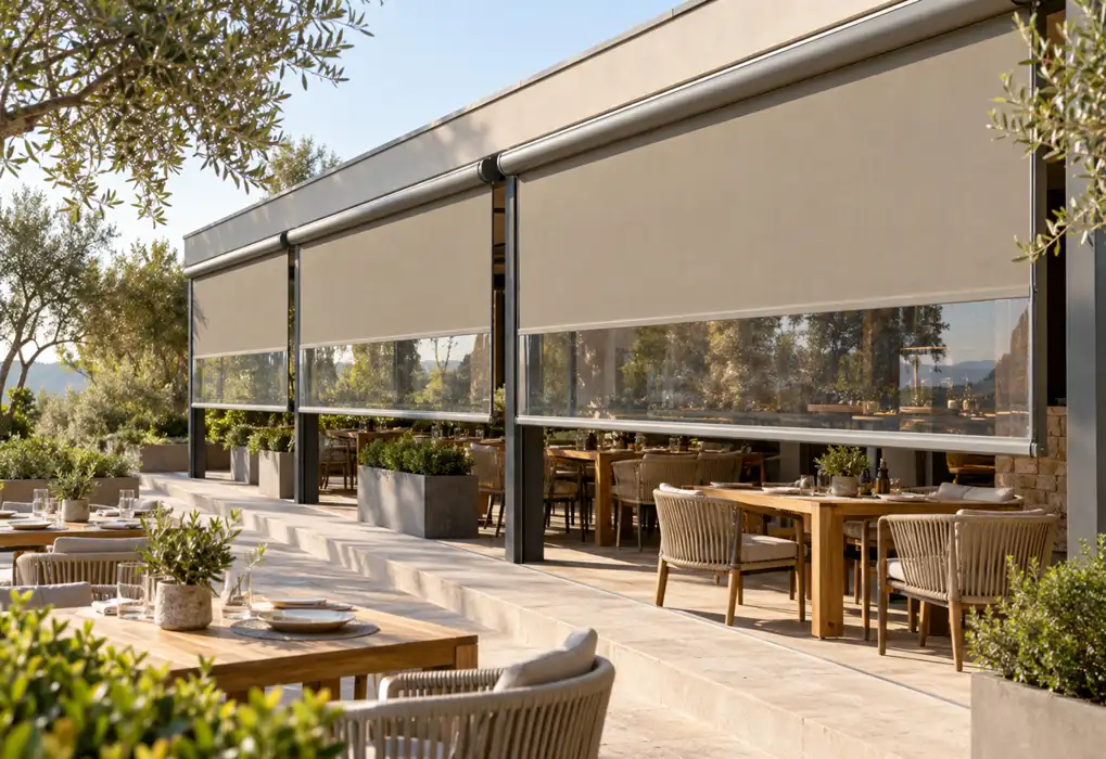 Taupe roller blinds above outdoor cafe tables