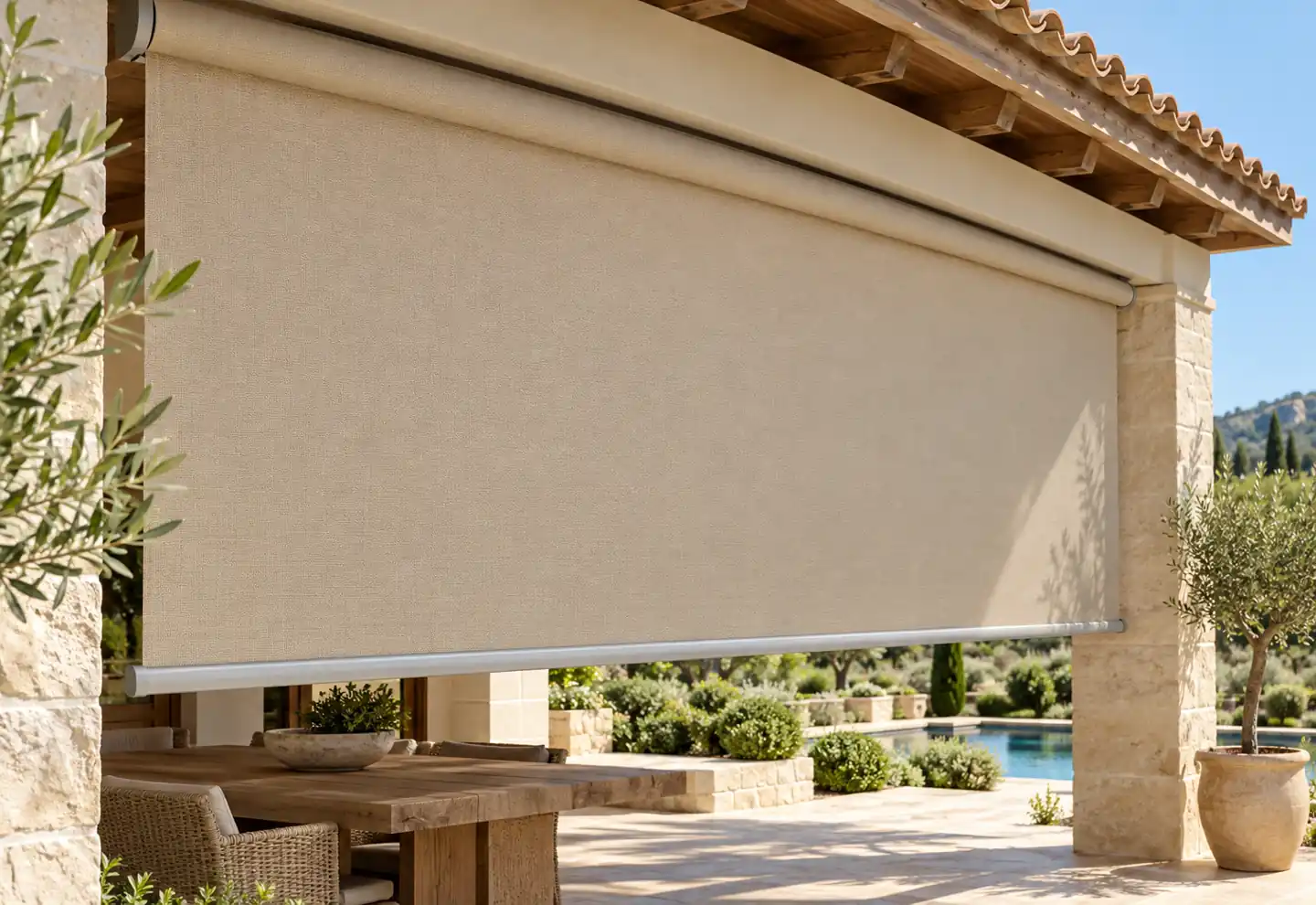 Beige canvas roller shade above patio dining