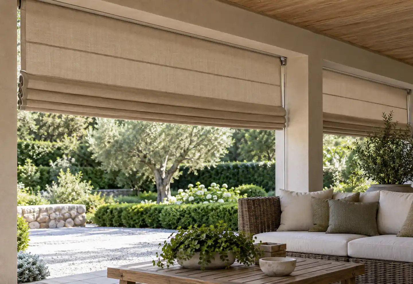 Beige Roman shade on a garden veranda